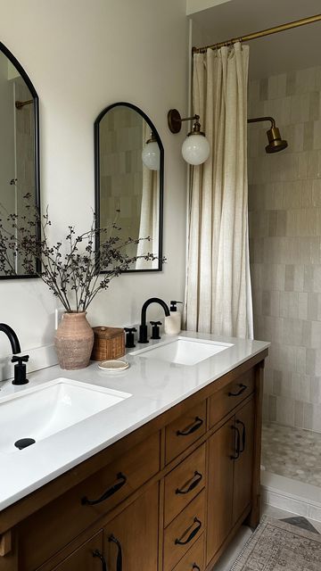 a bathroom with two sinks and mirrors in it