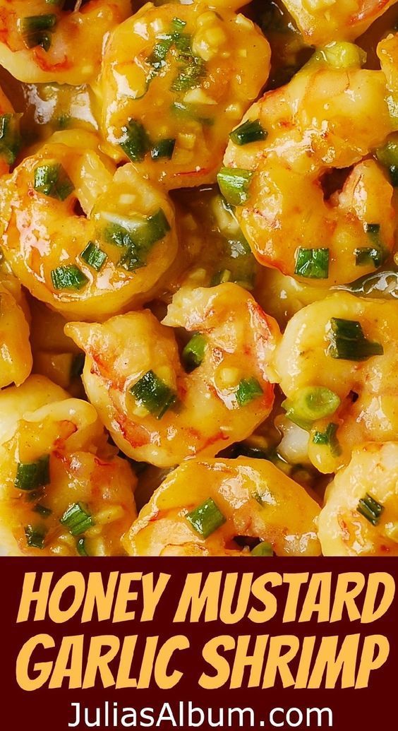 cooked shrimp with green onions and sauce in a white bowl