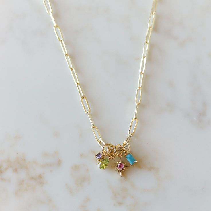 The perfect gift for the hard to buy! Our Family Charm Necklace features a paper clip chain with birthstone charms dangling from it. This necklace is perfect for layering or wearing alone to dress up your casual outfit. *Birthstone Charms are available in the shapes: teardrop, round, rectangle, and star *This chain necklace is available in: 16" length, 18" length, or 20" length Simple Gifts For Mom, Minimalist Charm Necklaces, Chain Charm Necklace, Dainty Charm Necklace, Diy Charm Necklace, Charm Necklace Ideas, Mom Necklaces, Birth Stone Necklace, Simple Charm Necklace