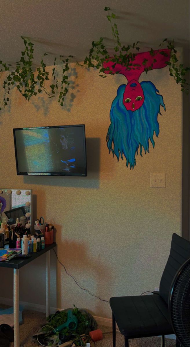 a living room with a television and plants on the wall