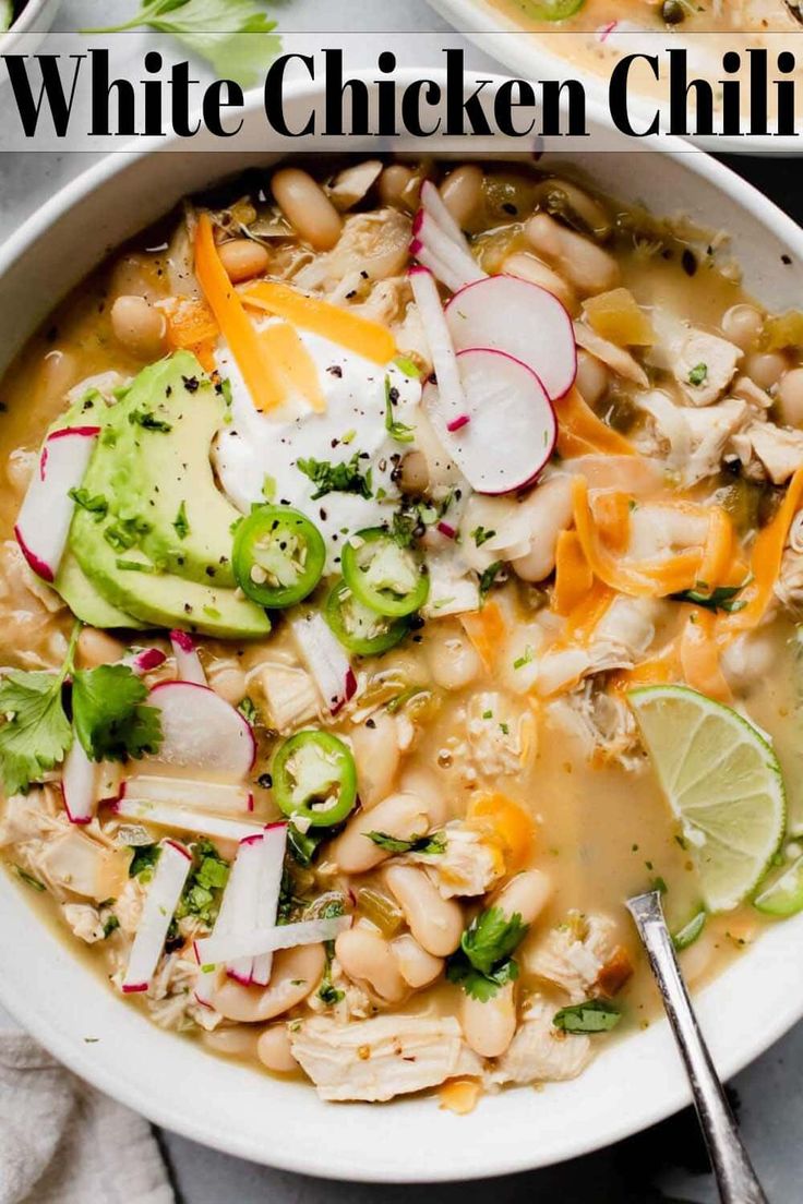 white chicken chili with avocado, radishes and cilantro in a bowl