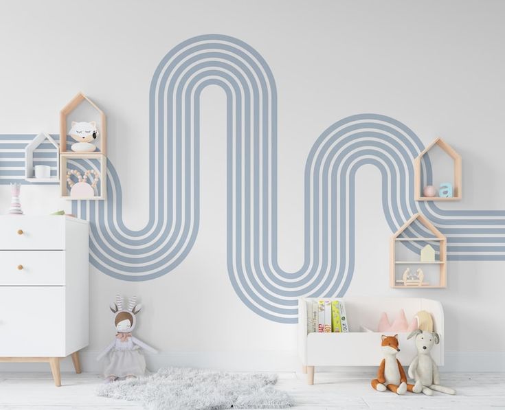 a child's room with blue and white stripes on the wall