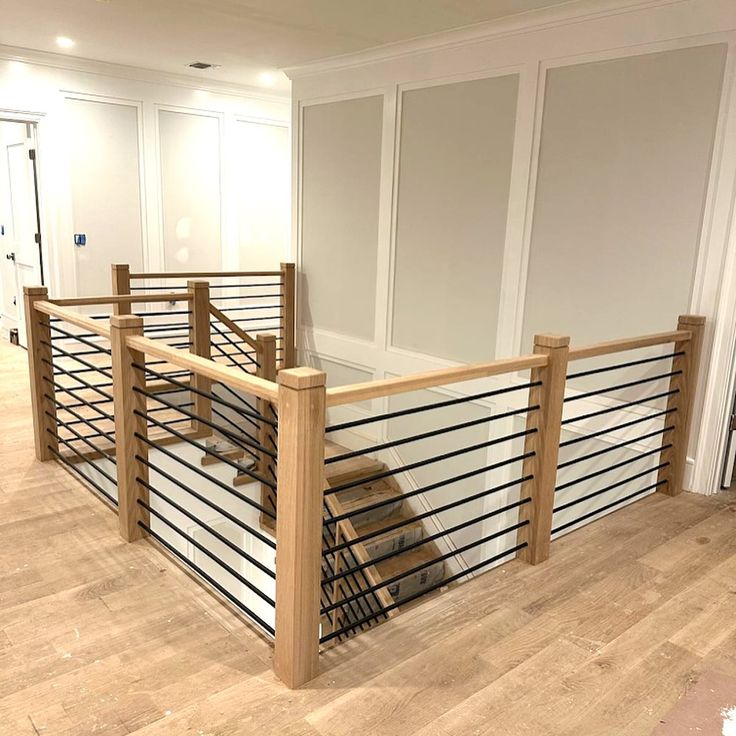 an empty room with wood and metal railings