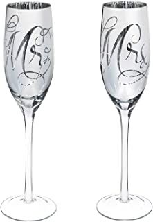 two wine glasses sitting next to each other on a white surface with the letters e and f