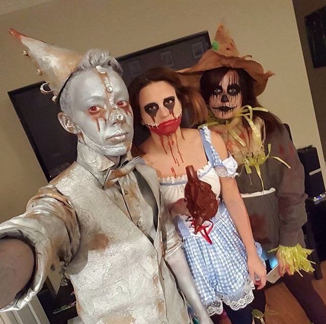 three people dressed in costumes standing next to each other