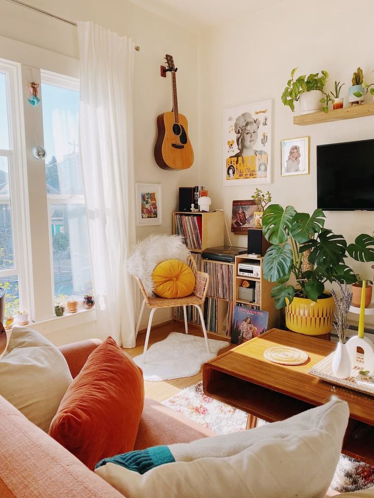 a living room filled with lots of furniture and a flat screen tv mounted to the wall