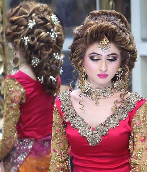 a woman in a red dress with gold jewelry