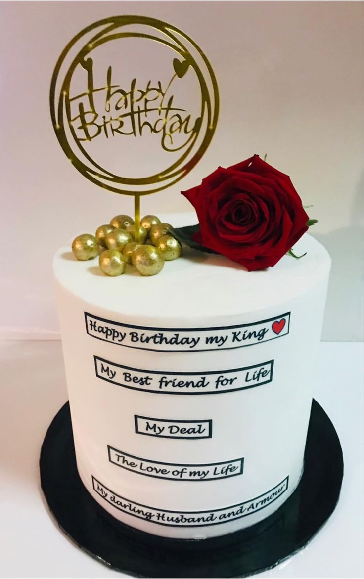 a birthday cake with a red rose on top