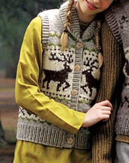 a woman wearing a knitted sweater with deers on it and a man standing next to her