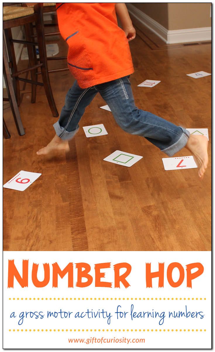 a young boy is running across the floor with numbers on it and words that read number hop