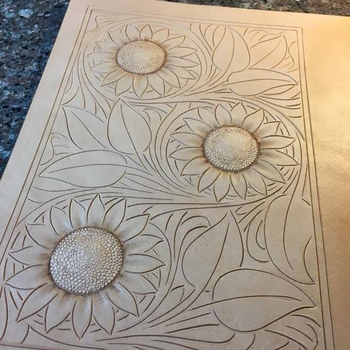 an intricately designed tile with three flowers on it's side, and two smaller petals