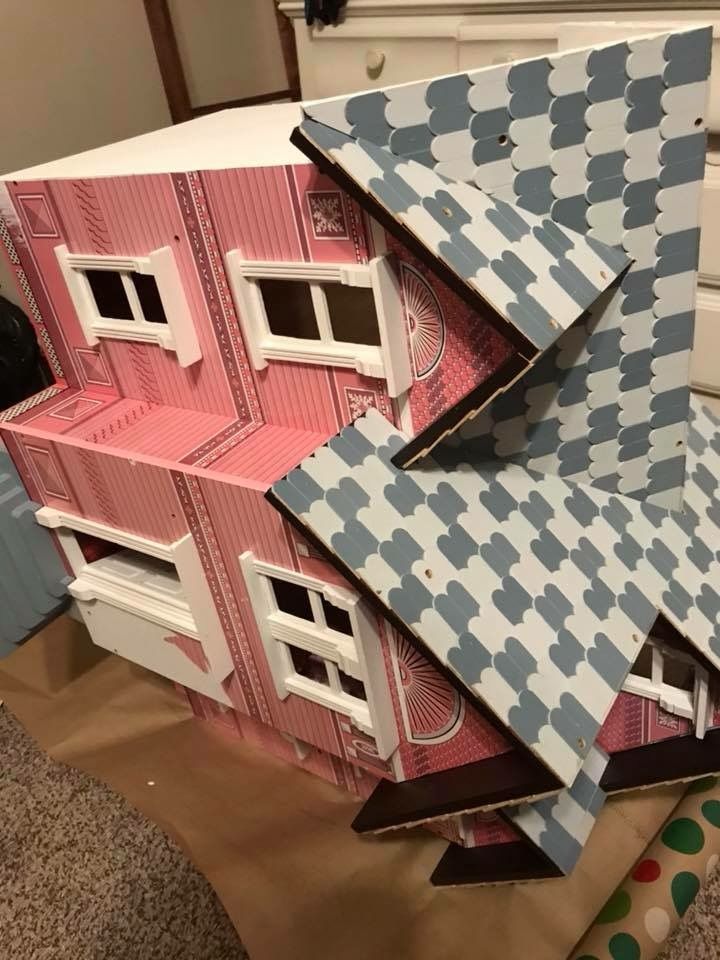 a doll house made out of cardboard sitting on the floor