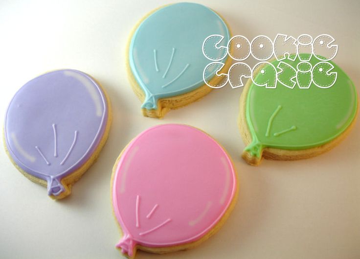 three decorated cookies in the shape of balloons