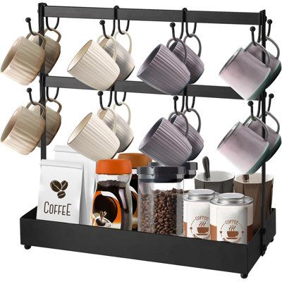 coffee mugs are hanging on the rack with cups