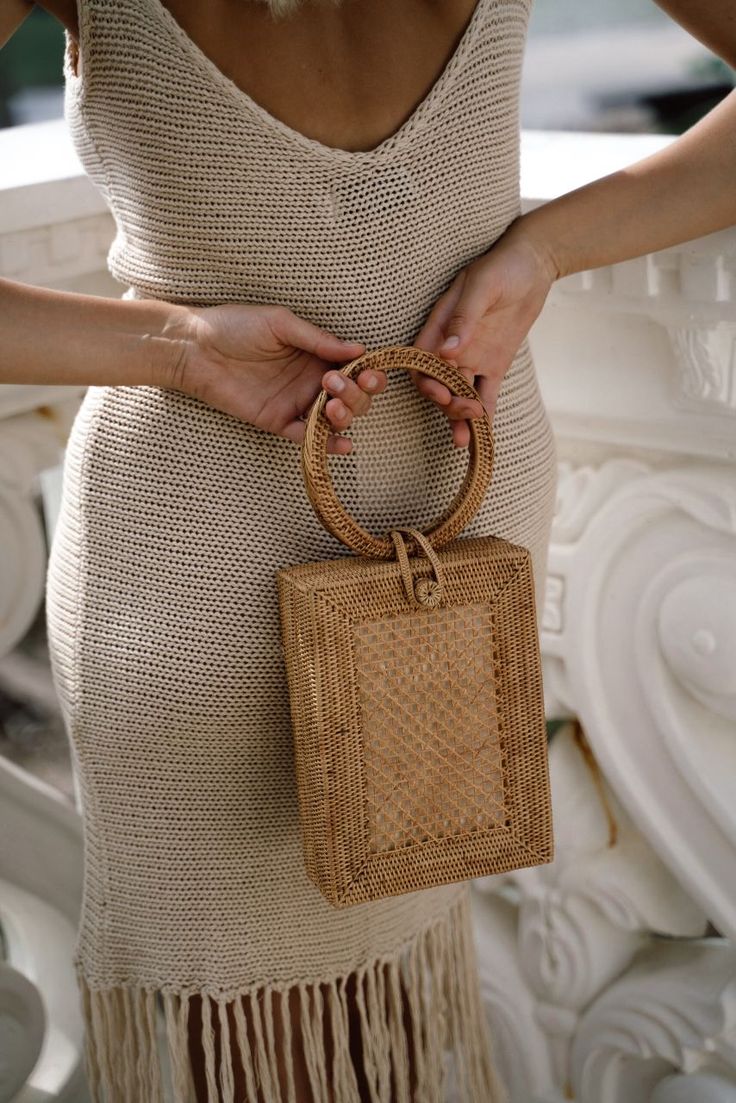 This basket bag was handwoven by a weaving artisan co-op in Bali, Indonesia, using locally sourced, renewable resources. This bag takes six weeks to weave, dry, and finish. Handles: Organic ata grass Body: Organic ata grass Lining: Organic 100% cotton canvas / Cream Dimensions 5.9 “ L x 2.3 “ W x 8.3 “ H / 15 cm L x 6 cm W x 21 cm H Handwoven Rectangular Bucket Bag In Natural Fiber, Eco-friendly Woven Bucket Bag With Top Handle, Rectangular Handwoven Natural Fiber Bucket Bag, Rectangular Straw Bag With Braided Handles For Market, Rectangular Straw Bucket Bag For Market, Eco-friendly Handwoven Rectangular Straw Bag, Handwoven Beige Bag With Round Handle, Rectangular Natural Straw Bag With Bamboo Handle, Beige Handwoven Bag With Round Handle