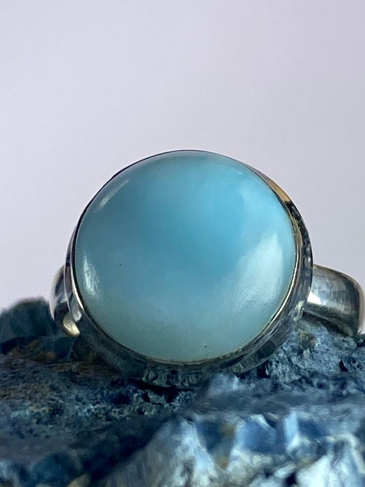 An exceptionally majestic Natural Dominican Larimar and 925 silver ring. This stone is a good size and is of a tranquil, blue coral colour Larimar cabochon set in a fine detailed silver setting. This decorate setting adds complexity and flair to the piece.  Larimar is the embodiment of the tranquil Sea and Sky energies. Its soft, soothing blues and calming turquoise is streaked with white patterns that resemble sunlight dancing beneath Caribbean waters. It brings the ancient wisdom of Atlantis a Coral Colour, Tranquil Blue, Blue Coral, Healing Power, 925 Silver Ring, Coral Blue, Ancient Wisdom, Coral Color, Atlantis