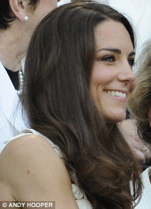 the duke and princess of cambridge smile as they sit next to each other at an event