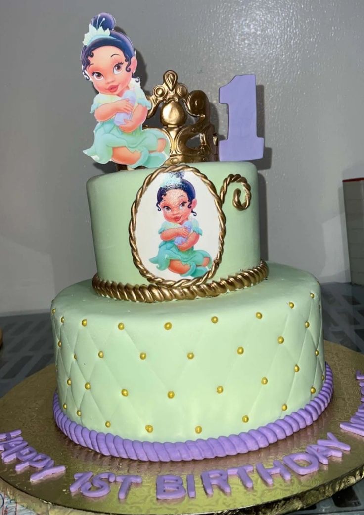 a birthday cake decorated with an image of princess and prince on it's top