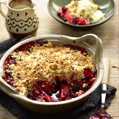 a bowl filled with crumbled food next to another bowl full of desserts