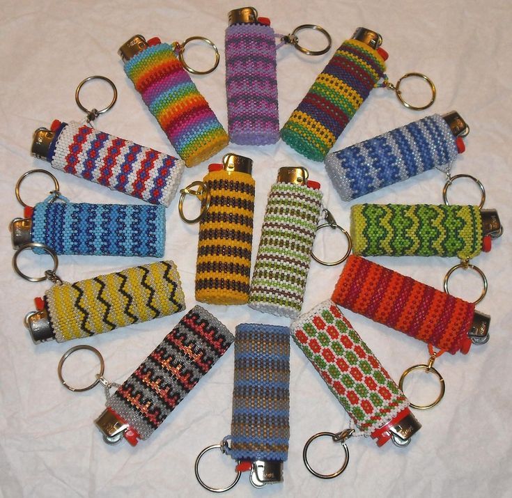 a group of multicolored knitted key chains arranged in a circle