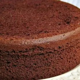 a chocolate cake sitting on top of a white plate