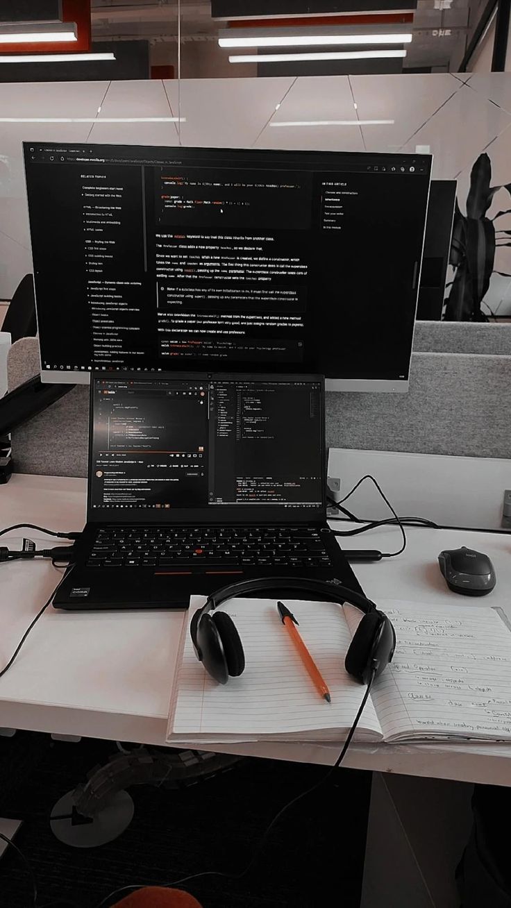 an open laptop computer sitting on top of a desk next to a mouse and keyboard