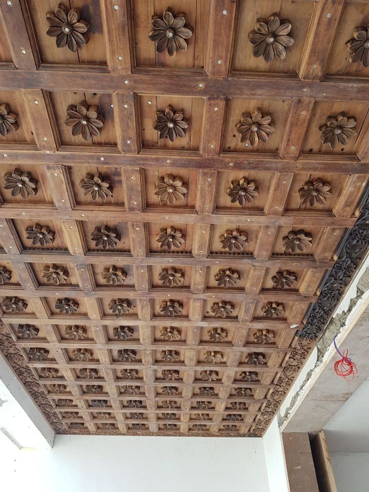 the ceiling is decorated with wooden carvings