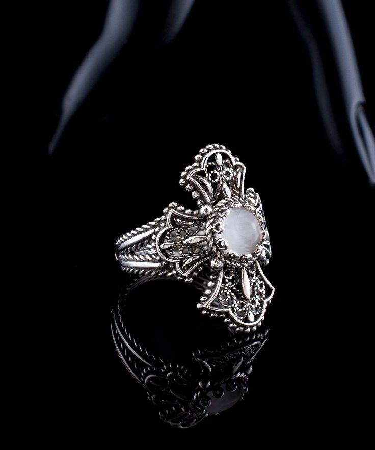 Mother of Pearl Silver Filigree Cross Ring, 925 Sterling Artisan Handmade White Pearl Stone, Women Celtic Cross Ring, Religious Jewelry Christian gift ring, Clover Cross Ring, Valentines day gift, goth girl ring, june birthstone ring, victorian cross ring, birthday gift ring Material: 925 Sterling Silver ( NICKEL FREE ) Gemstone: Mother of Pearl 6mm, round cut Show off this gorgeous Cross ring at any occasion. This eye catching ring is perfect to add glam to any outfit. The vintage style, stylish luxury jewelry is perfect for wearing at everyday life and any special occasion. FAST AND TRACKABLE SHIPPING FOR ALL EU COUNTRIES AND USA. COMES WİTH VELVET POUCH AND LUXURY GİFT BOX. Our handmade pieces are the perfect gift ring for her, mom, wife, daughter, friend, lover, relative, etc. ideal gi Fine Jewelry Silver Hallmarked Moonstone Ring, Spiritual Sterling Silver Rings With Intricate Design, Handmade Silver Victorian Rings, Handmade Victorian Silver Rings, Sterling Silver Filigree Ring With Oxidized Finish For Wedding, Spiritual Filigree Ring Jewelry, Elegant Engraved Silver Moonstone Ring, Engraved Silver Moonstone Ring Gift, Silver Sterling Silver Filigree Ring