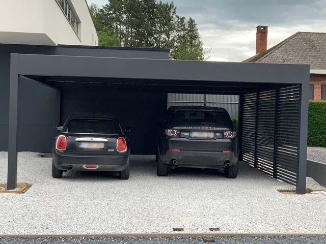 two cars are parked in the garage with their doors open and one car is black