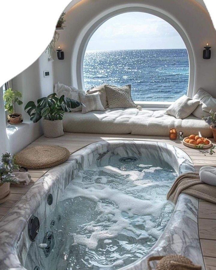 an indoor jacuzzi tub in the middle of a room with a large window