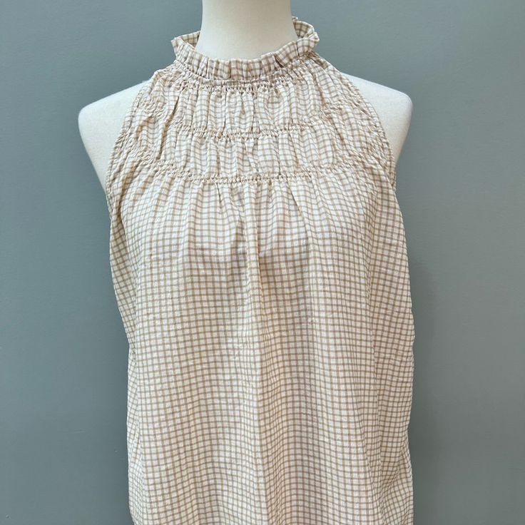 Size Medium Sleeveless Blouse. Smocked Details At Neckline Make This A Cute Option To Wear With Shorts Or Jeans. Neutral Color That Will Compliment Most Other Colors. Msrp: $58.00 Beige Sleeveless Tank Top For Daywear, Chic Sleeveless Smocked Top For Day Out, Chic White Top With Elastic Neckline, Chic Beige Sleeveless Halter Top, Summer Sleeveless Cotton Smocked Top, Summer Cotton Sleeveless Smocked Top, Sleeveless Smocked Top For Day Out, Beige Tank Top For Daywear, Spring Sleeveless Tank Top With Smocked Back