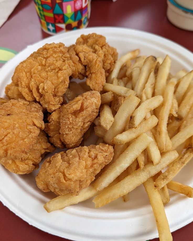 fried chicken and french fries on a paper plate