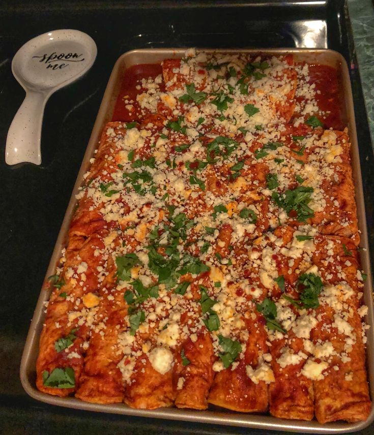 a pan filled with food sitting on top of a stove