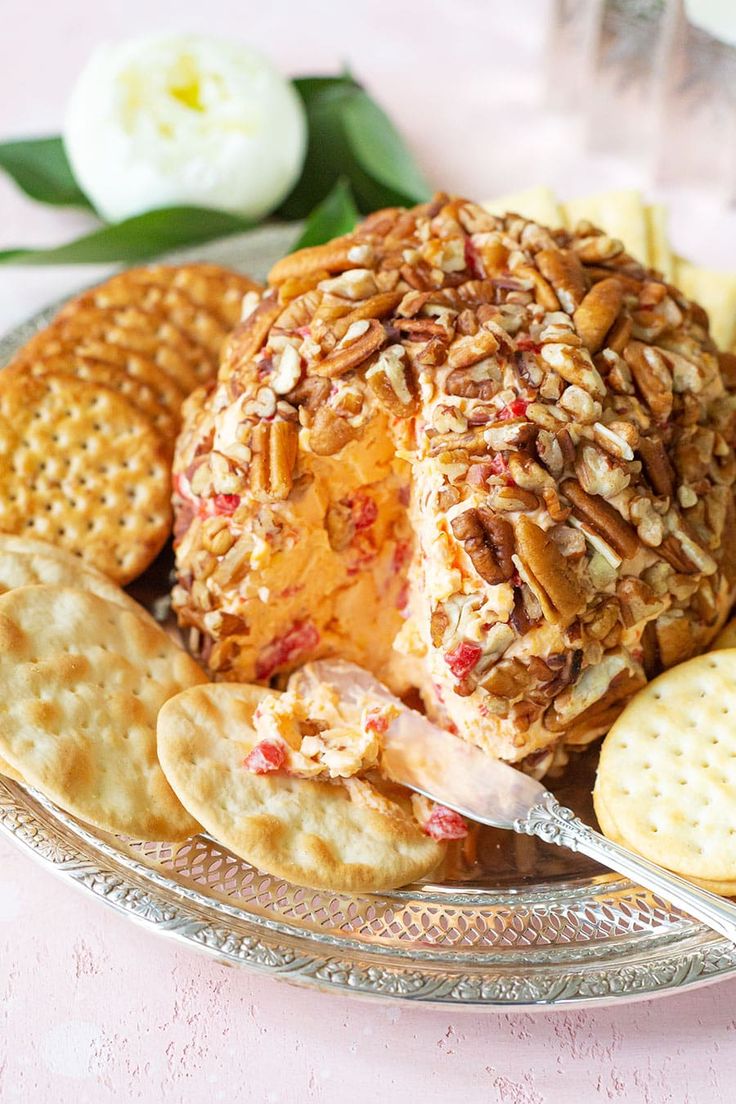 a plate with crackers and cheese ball on it