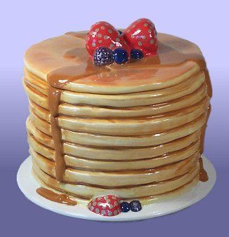 a stack of pancakes with strawberries on top