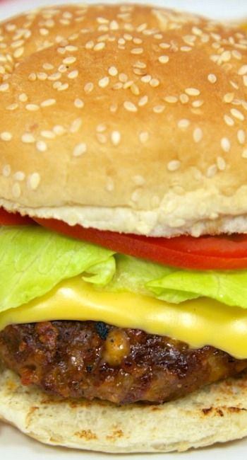 a hamburger with lettuce, tomato and cheese