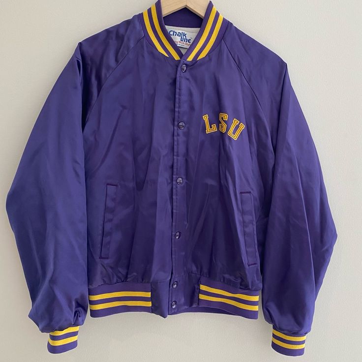 Louisiana State University Excellent Condition For This Vintage Jacket - Few Hard To Notice Blemishes Expected With Age But No Rips Or Tears Signature Satin Bomber Jacket With Purple And Gold Striped Wrists, Collar, And Waist Length: 24” Armpit To Armpit: 20” Purple Cotton Outerwear With Pockets, Collegiate Cotton Outerwear For Spring, Classic Purple Outerwear With Pockets, Casual Purple Long Sleeve Varsity Jacket, Casual Purple Varsity Jacket For Winter, Casual Purple Cotton Outerwear, Casual Purple Outerwear For College, Purple Varsity Outerwear For College, Casual Purple Varsity Jacket For College