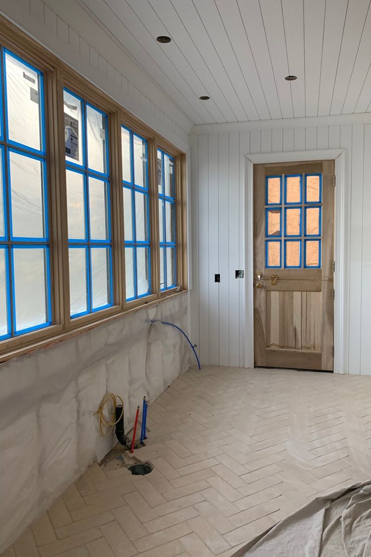 an empty room with white walls and blue windows