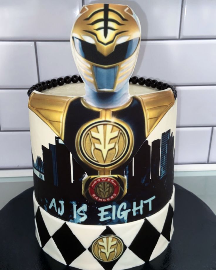 a cake that is decorated to look like the power rangers helmet on top of it