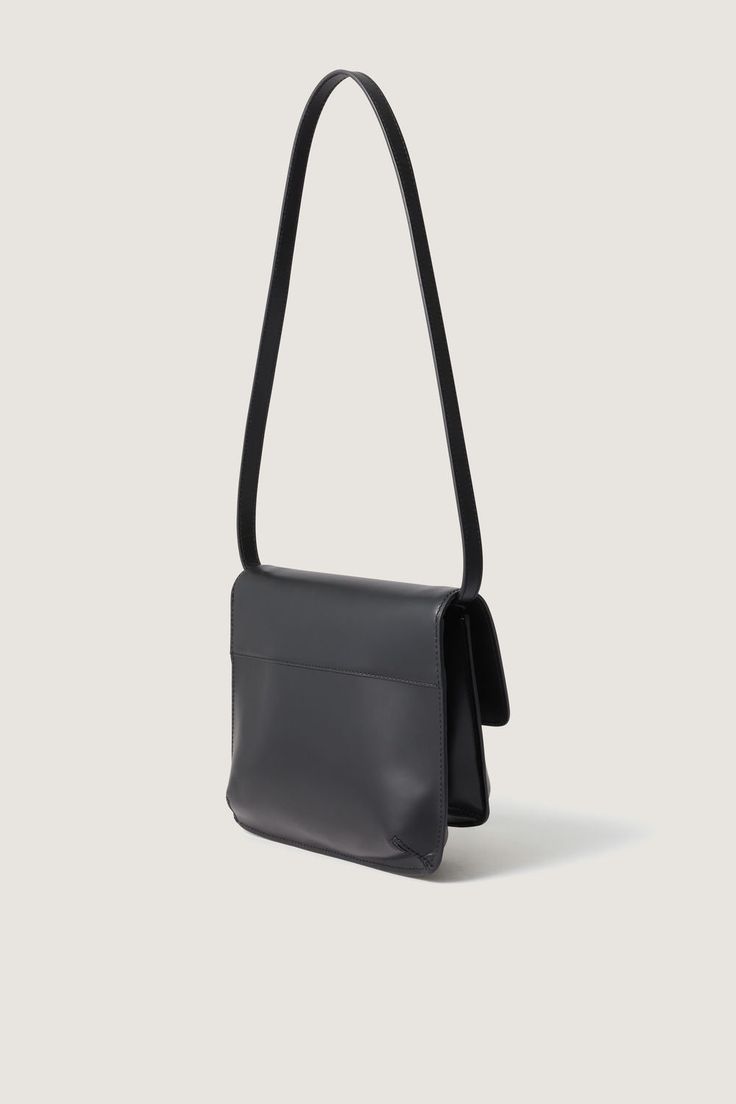 Black glazed leather bag - Shoulder bag- Two pleats- Cotton lining- Card holder inside- Height 18 cm, length 25 cm- LWG leather This piece is made of LWG GOLD certified leather. Rectangular Saddle Bag With Removable Pouch For Evening, Modern Rectangular Saddle Bag For Evening, Modern Rectangular Saddle Bag For Evenings, Classic Evening Saddle Bag With Removable Pouch, Versatile Rectangular Saddle Bag For Formal Occasions, Sleek Formal Shoulder Bag With Removable Pouch, Versatile Formal Rectangular Saddle Bag, Formal Rectangular Versatile Saddle Bag, Leather Rectangular Evening Saddle Bag