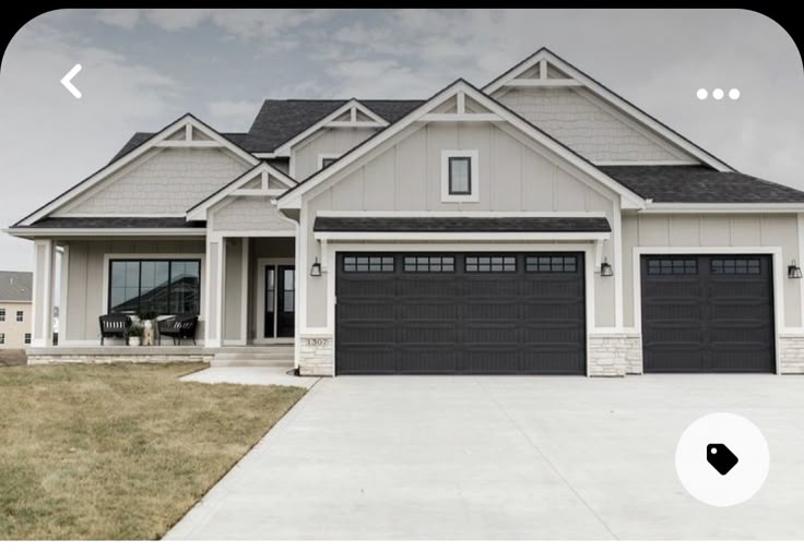 a large house with two garages in front of it