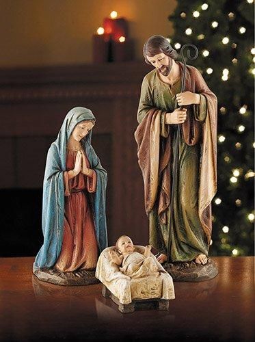 a nativity figurine depicting the birth of jesus and mary with a lit christmas tree in the background