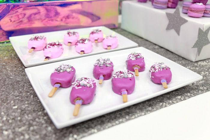 pink and white desserts are displayed on plates