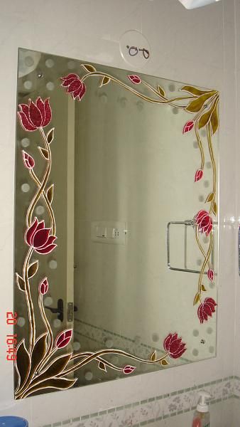 a bathroom mirror with flowers painted on it