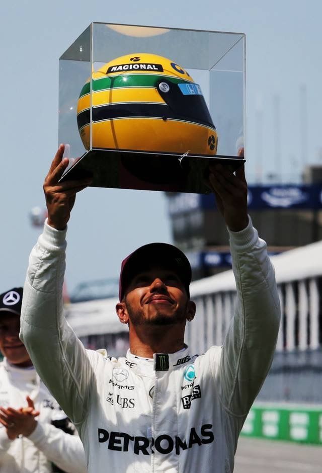 a man holding up a helmet on top of his head