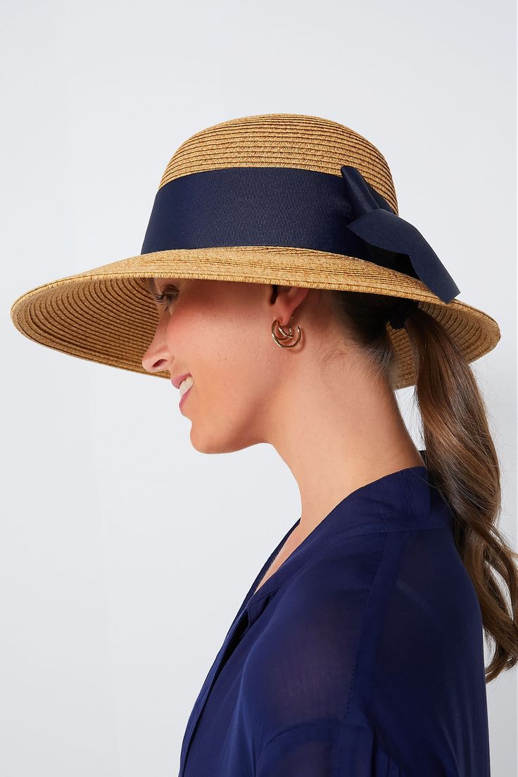 Toucan Hats makes our best-selling and beloved beach accessories.This bow-trimmed hat offers pretty protection from the sun with a nautical navy ribbon detail. Wear to the beach with your favorite caftan for a classic, feminine, and practical finishing touch. The best part? It's packable so it will easily fit in your suitcase or weekender, and keeps its shape after you pull it out. Wide brim Navy bow detail Packable Material: Woven Straw Navy Hat For Spring, Chic Sun Hat With Bow For Vacation, Chic Vacation Sun Hat With Bow, Elegant Lightweight Boater Hat For Beach, Navy Beach Hat, Chic Blue Straw Hat For The Beach, Navy Beach Hat For Summer, Chic Sun Hat With Bow For Summer, Chic Beach Sun Hat With Bow