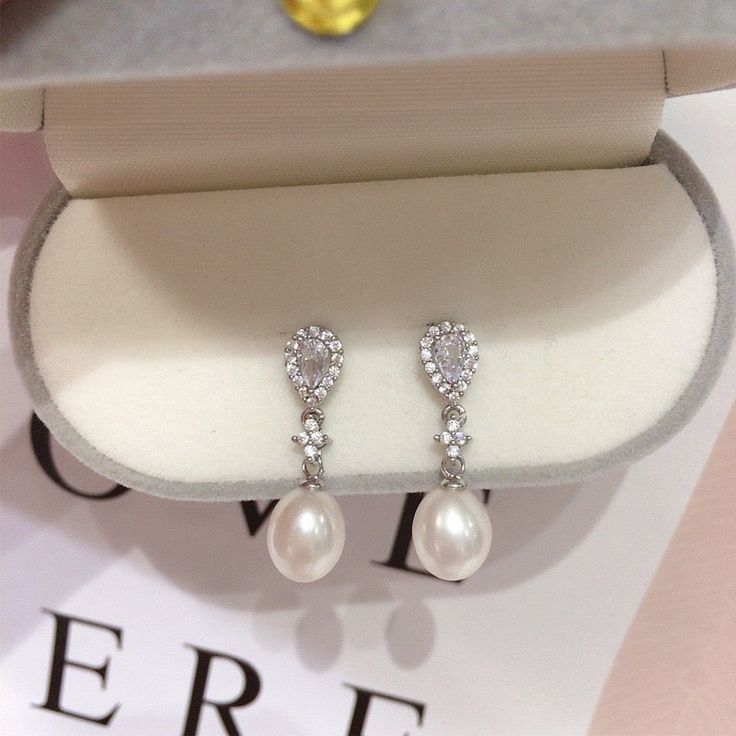 These stunning earrings feature lustrous oval pearls, accented with sparkling water drop-shaped zircons. The 18K gold plating adds a touch of modernity and makes them long-lasting, non-tarnishing for years! Pearl Type: Freshwater Pearls Pearl Quality: [Shape]: Oval [Size]: 8-9mm [Blemish]: None [Luster]: High Material: 18k Gold Plated Brass Note: Every pearl is unique. Items may vary from the pictures. Elegant Oval Pearl Drop Earrings, Formal Teardrop Pearl Earrings With Cubic Zirconia, Elegant Oval Teardrop Earrings For Formal Occasions, Wedding Oval Pearl Earrings, Teardrop Pearl Earrings With Cubic Zirconia For Party, Elegant Teardrop Pearl Earrings With Cubic Zirconia, Cubic Zirconia Teardrop Pearl Earrings For Anniversary, Teardrop Cubic Zirconia Pearl Earrings For Anniversary, Elegant Oval Pearl Earrings