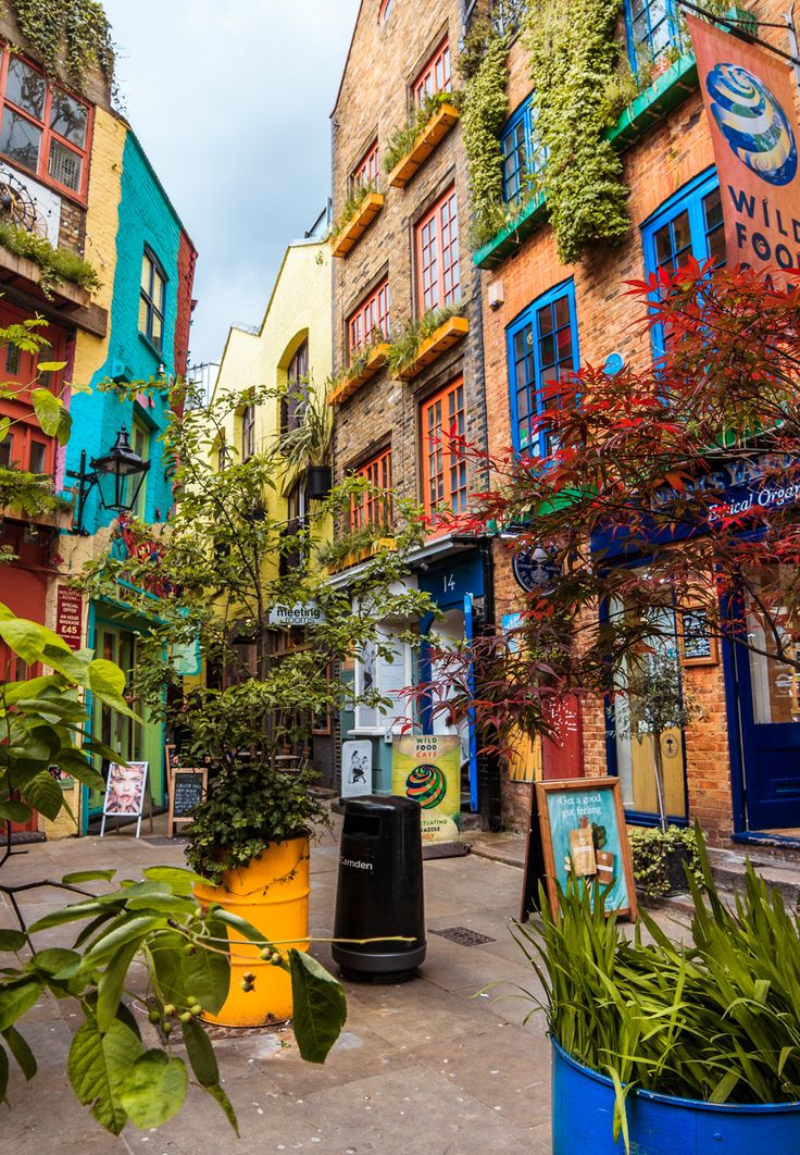 an alleyway with colorful buildings and plants