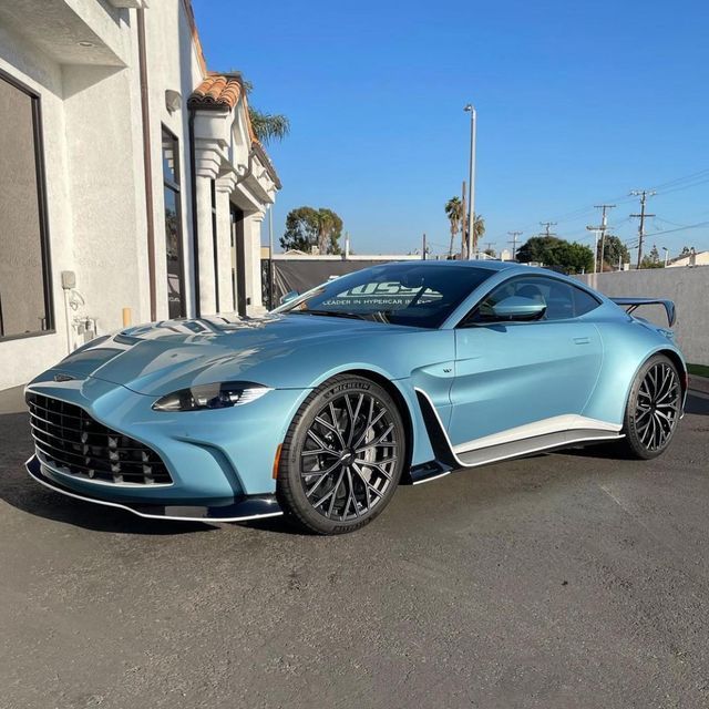 a blue sports car parked in front of a building