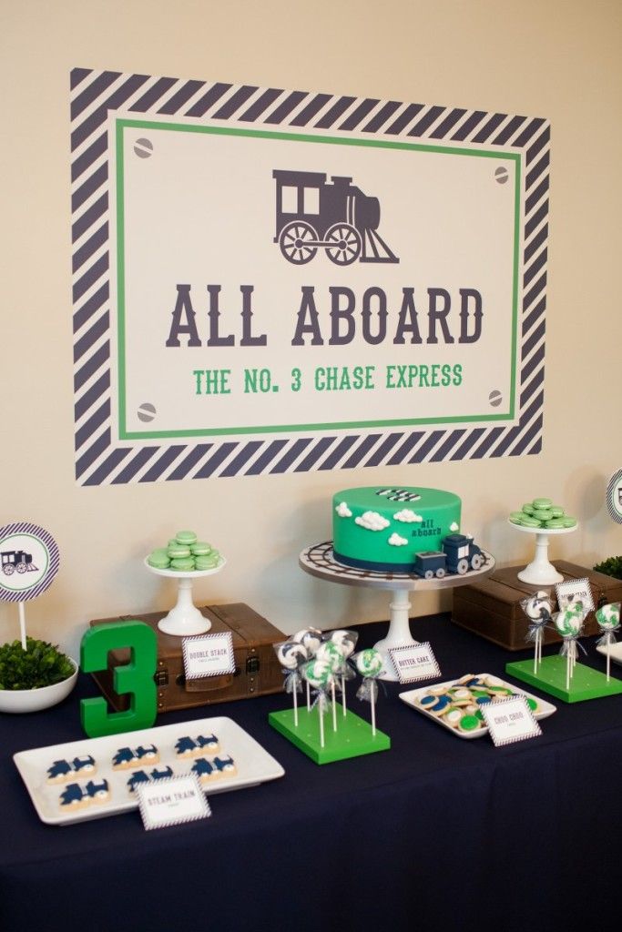 a table topped with cakes and desserts next to a sign that says all aboard the no 3 chase express